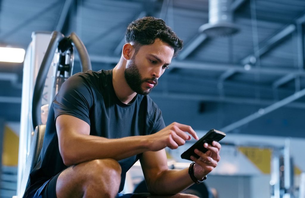 Man on phone at gym