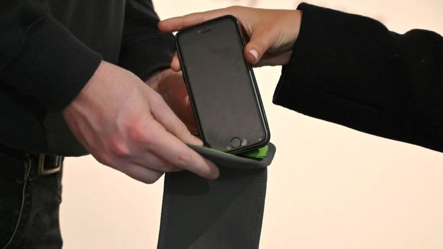 putting the phone in a lockable phone pouch